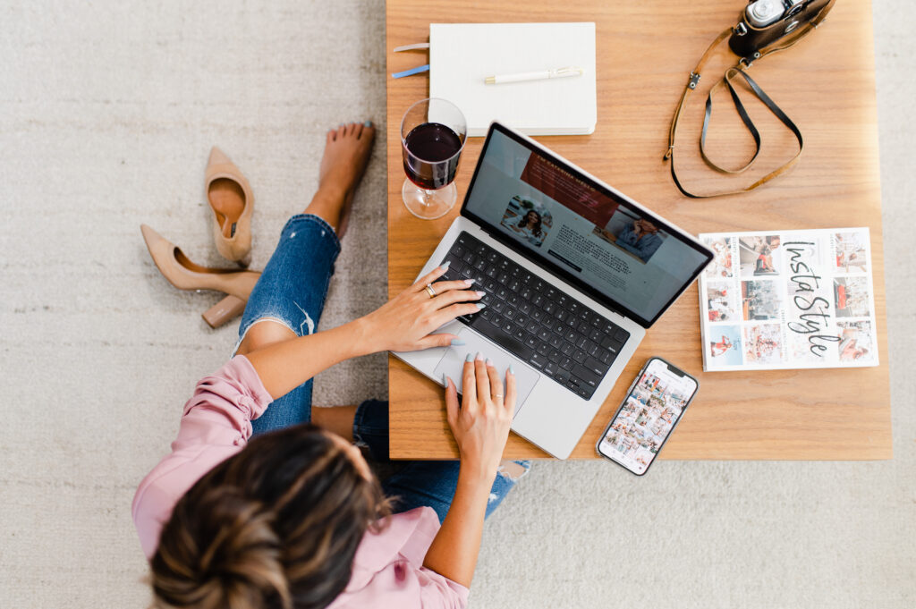 Content creator working on a laptop surrounded by tools of creativity, searching for Instagram story inspiration and overcoming creative block to stay consistent.